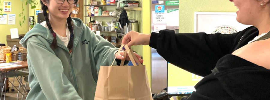 6 of 7, Student leader handing out personal hygiene bag to a UC San Diego student.