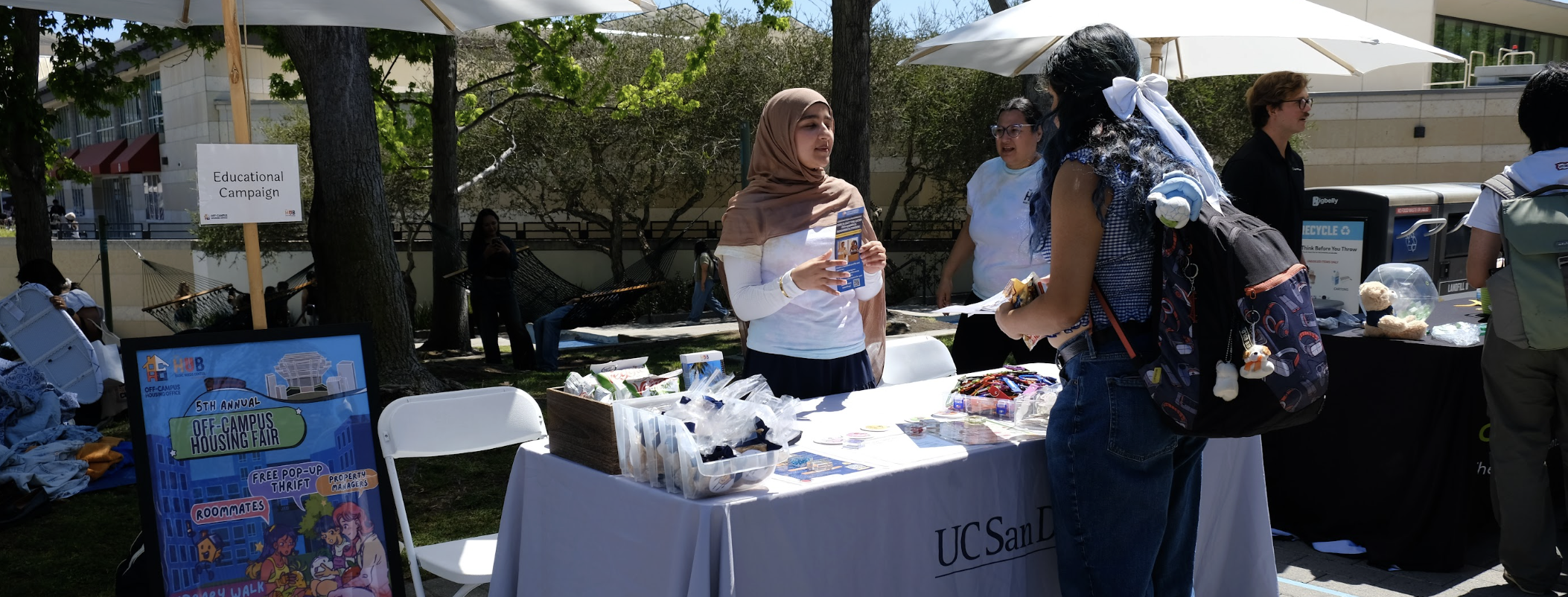 4 of 4, Off campus housing fair peer educator helping a ucsd student on a tabling event